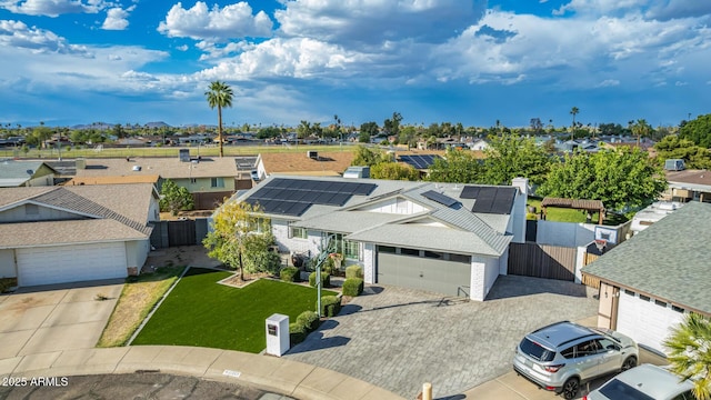 view of front of house with a garage, a front lawn, fence, a gate, and a residential view