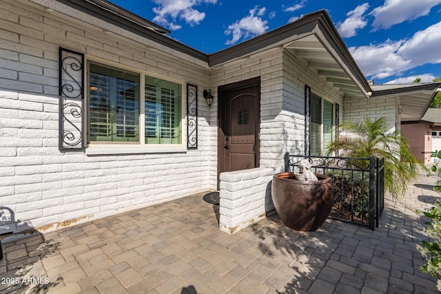 view of exterior entry featuring a porch
