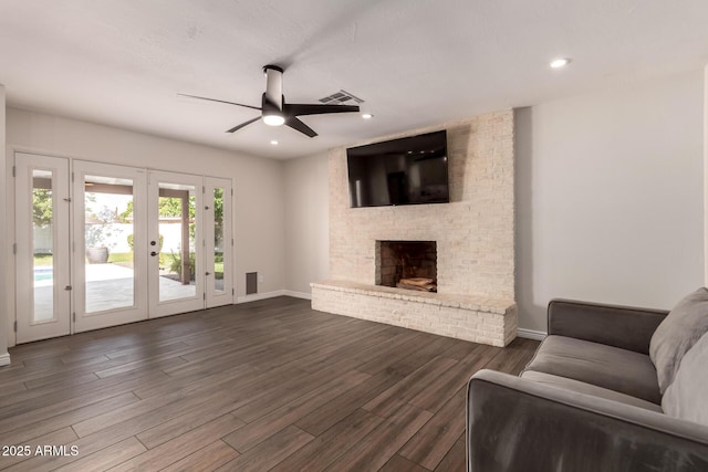living area with visible vents, baseboards, dark wood-style floors, french doors, and a ceiling fan