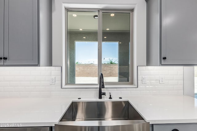 17322 W Puget Ave, Waddell, AZ 85355 - kitchen with gray cabinetry, light countertops, and decorative backsplash