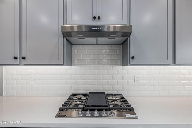 17322 W Puget Ave, Waddell, AZ 85355 - kitchen with stainless steel gas cooktop, range hood, light countertops, and tasteful backsplash