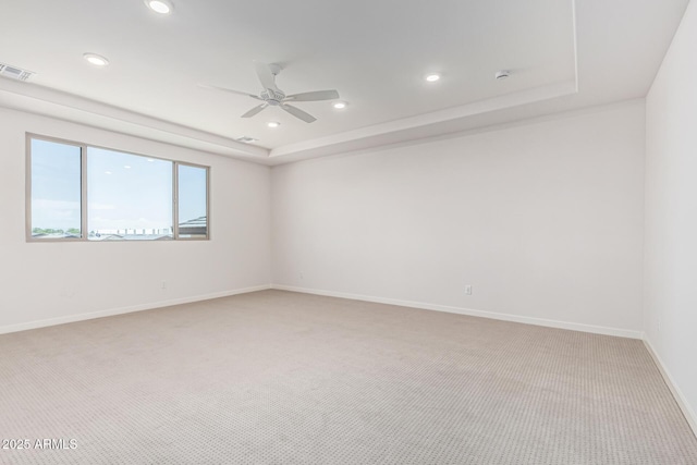 17322 W Puget Ave, Waddell, AZ 85355 - spare room featuring light carpet, ceiling fan, a raised ceiling, and recessed lighting
