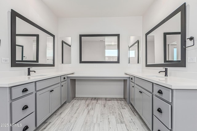 17322 W Puget Ave, Waddell, AZ 85355 - full bathroom with two vanities, wood finished floors, and plenty of natural light