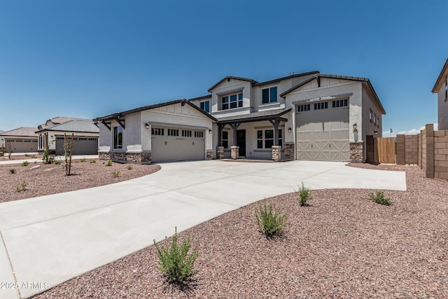 17322 W Puget Ave, Waddell, AZ 85355 - view of front of property featuring stone siding, an attached garage, concrete driveway, and stucco siding