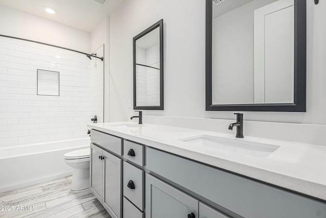 17322 W Puget Ave, Waddell, AZ 85355 - full bathroom with double vanity, tub / shower combination, and wood finished floors