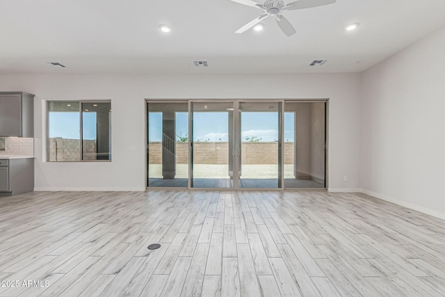 17322 W Puget Ave, Waddell, AZ 85355 - empty room with healthy amount of natural light, light wood finished floors, ceiling fan, and recessed lighting