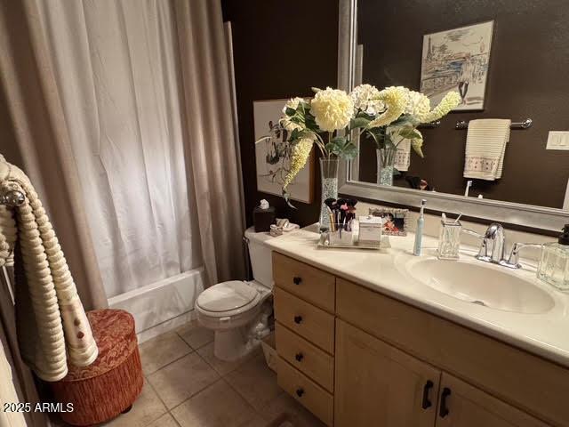 full bathroom featuring tile patterned floors, vanity, toilet, and shower / tub combo with curtain