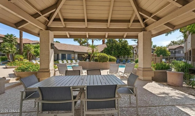 view of patio / terrace with a community pool and a gazebo