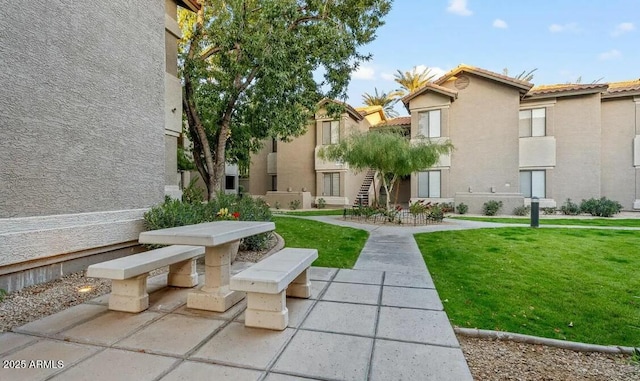 surrounding community featuring a lawn and a patio