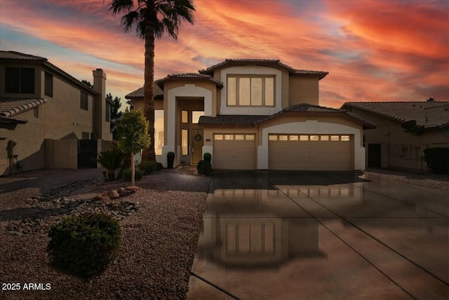 mediterranean / spanish-style house with a garage