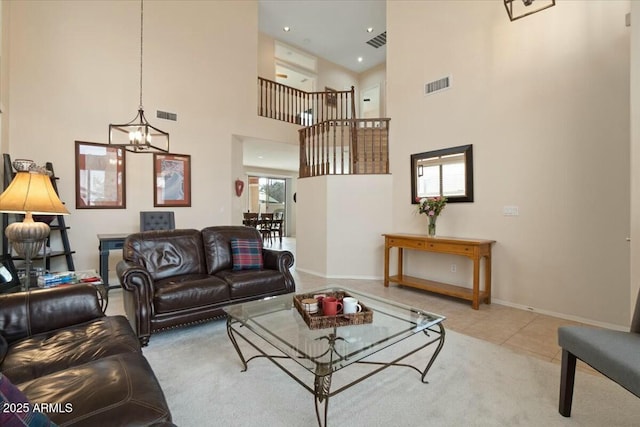 tiled living room with a notable chandelier