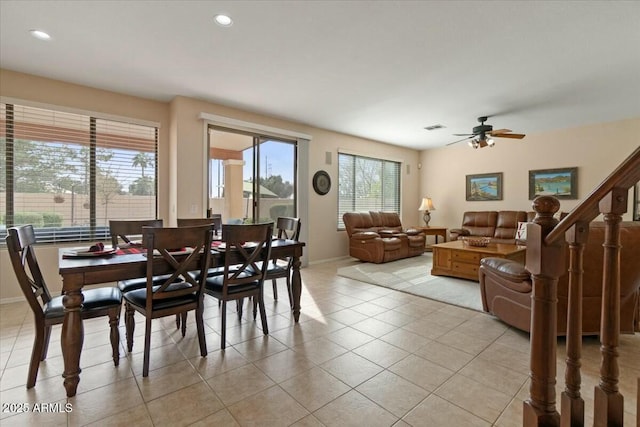 dining space with light tile patterned floors and ceiling fan