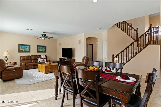 tiled dining space with ceiling fan