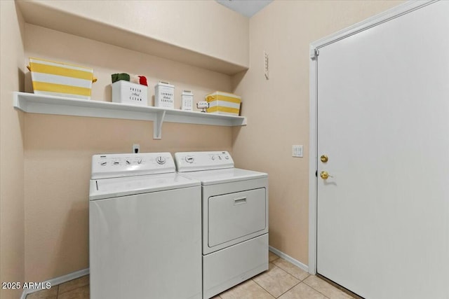 laundry room with light tile patterned flooring and washer and dryer