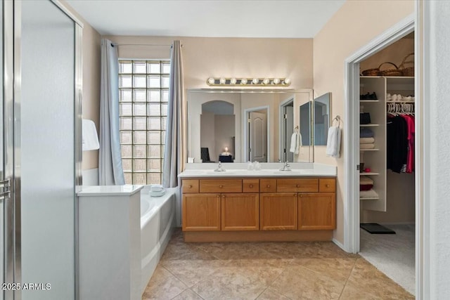 bathroom with vanity, tile patterned flooring, and plus walk in shower