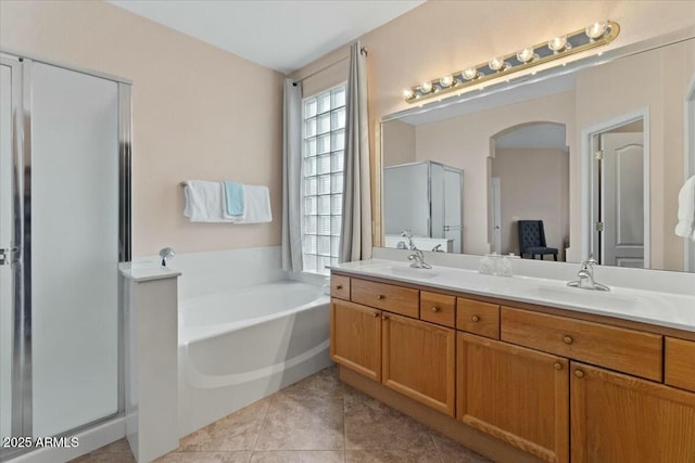 bathroom featuring vanity, separate shower and tub, and tile patterned floors