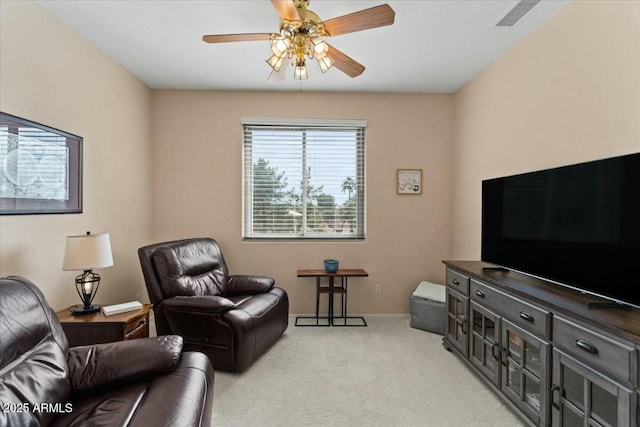 carpeted living room featuring ceiling fan