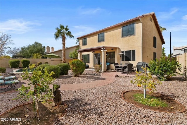 rear view of property featuring a patio