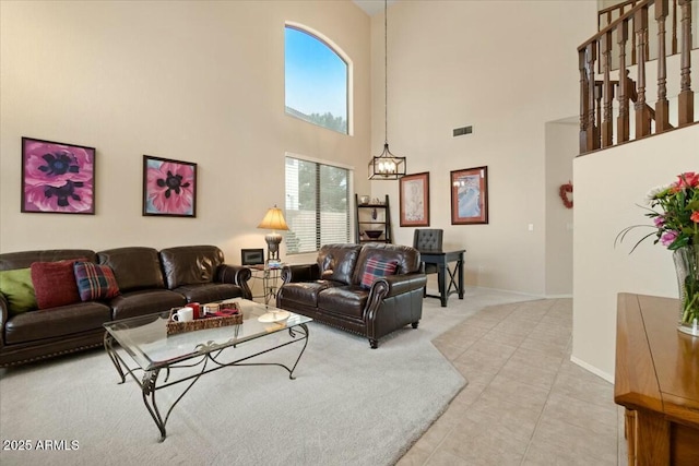 living room featuring a notable chandelier and light tile patterned floors