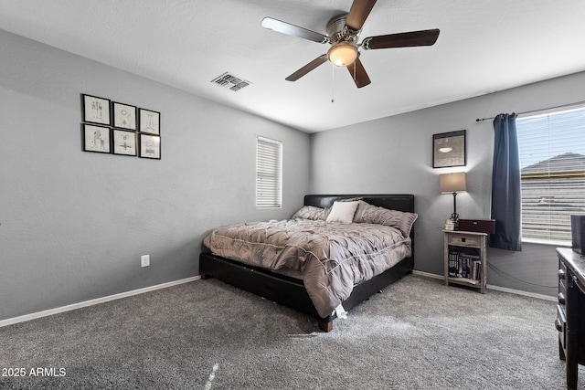 bedroom with a ceiling fan, visible vents, baseboards, and carpet flooring