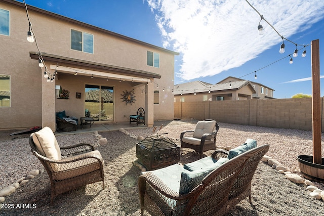 back of property with an outdoor hangout area, a patio area, fence private yard, and stucco siding