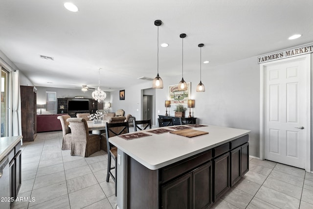 kitchen with visible vents, light countertops, decorative light fixtures, and open floor plan