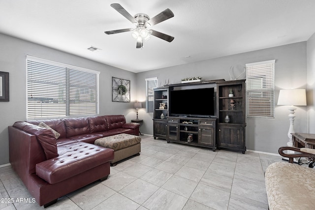 living room with baseboards, visible vents, a ceiling fan, and light tile patterned flooring