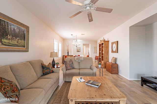 living room featuring light hardwood / wood-style floors and ceiling fan with notable chandelier