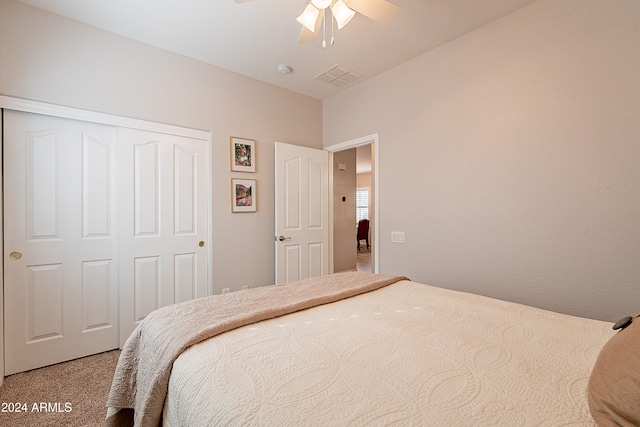 carpeted bedroom with ceiling fan and a closet