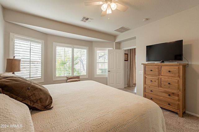 bedroom with light carpet and ceiling fan