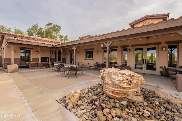 rear view of house with a patio area and french doors