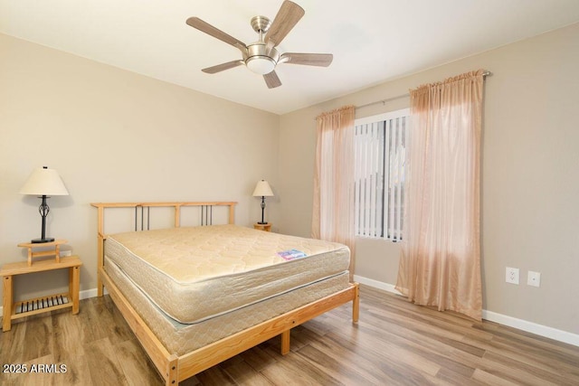 bedroom featuring wood-type flooring and ceiling fan