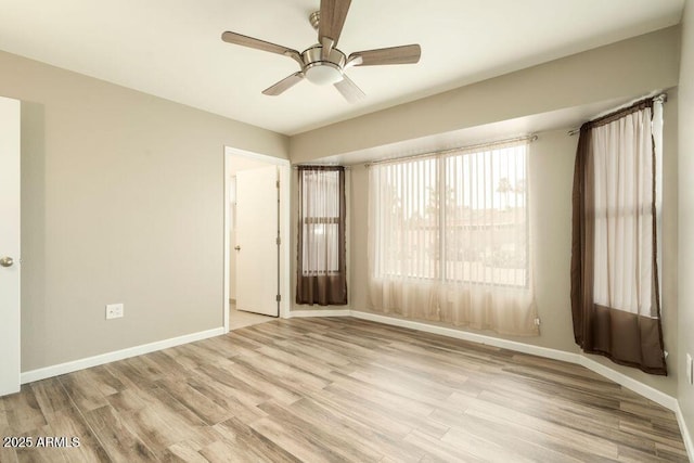 unfurnished room featuring ceiling fan and light hardwood / wood-style floors