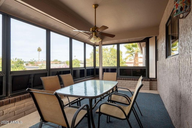 sunroom featuring ceiling fan