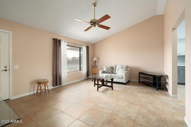 sitting room featuring ceiling fan, lofted ceiling, a textured ceiling, and light tile patterned floors