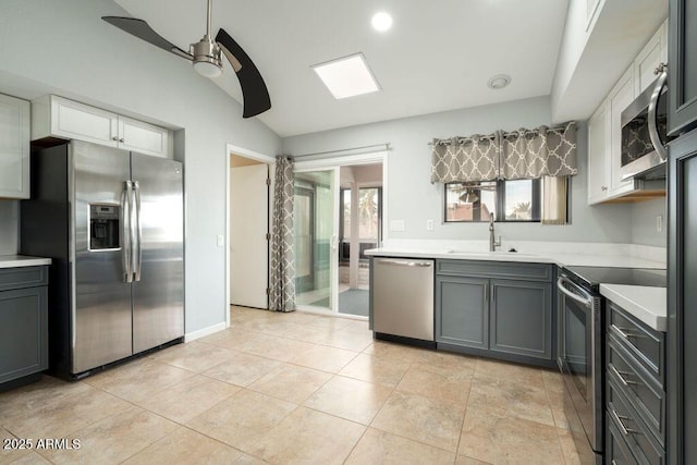 kitchen with sink, ceiling fan, gray cabinets, white cabinetry, and stainless steel appliances