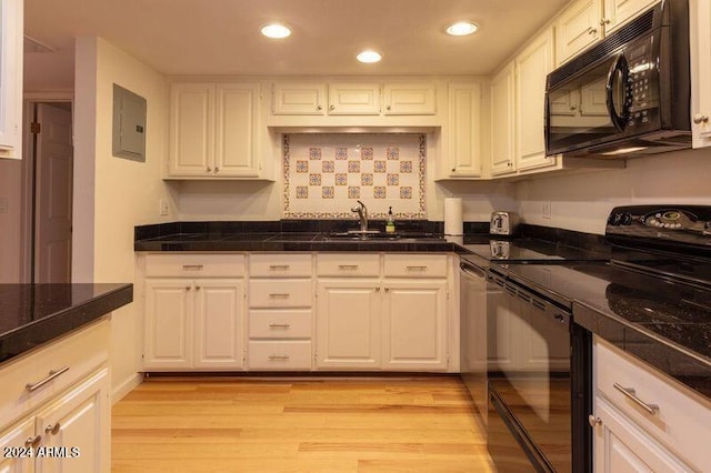 kitchen featuring electric panel, sink, white cabinetry, black appliances, and light wood-type flooring