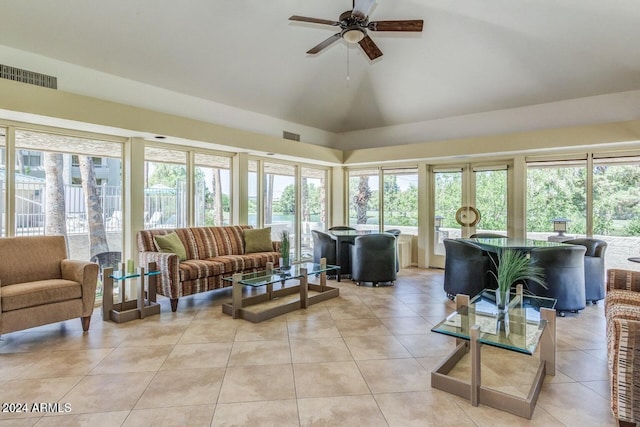 tiled living room featuring ceiling fan and high vaulted ceiling