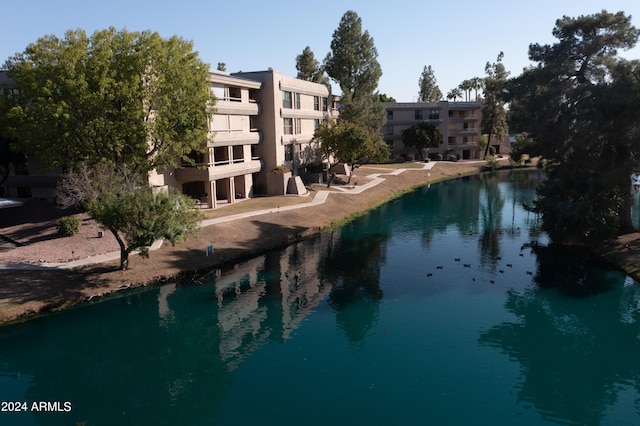 view of swimming pool with a water view