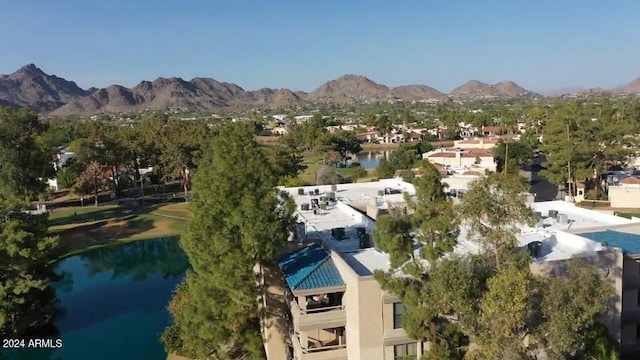 birds eye view of property with a water and mountain view