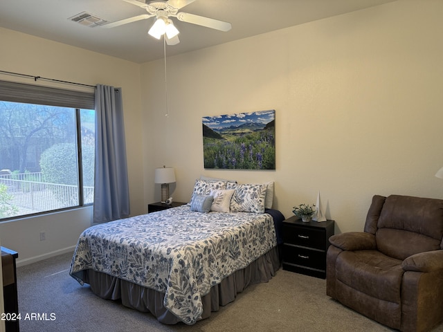 bedroom with visible vents, baseboards, light colored carpet, and a ceiling fan