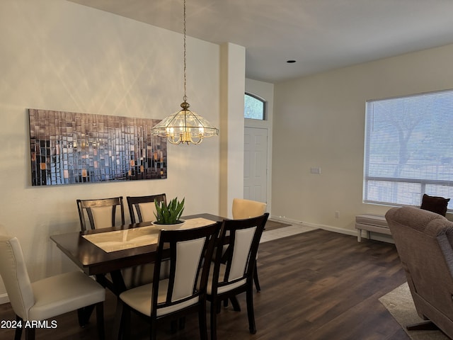 dining room featuring a notable chandelier, dark wood-style floors, and baseboards