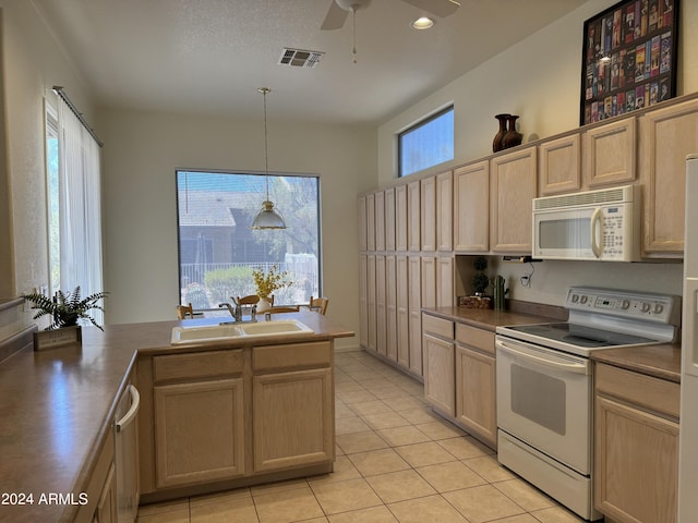 kitchen featuring visible vents, light brown cabinets, a sink, white appliances, and light tile patterned floors