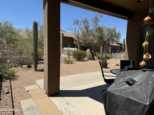 view of patio / terrace featuring grilling area, outdoor dining area, and fence