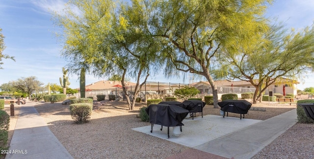 exterior space featuring grilling area and fence