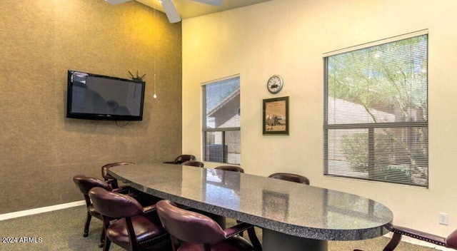 dining room with carpet flooring, a ceiling fan, and baseboards