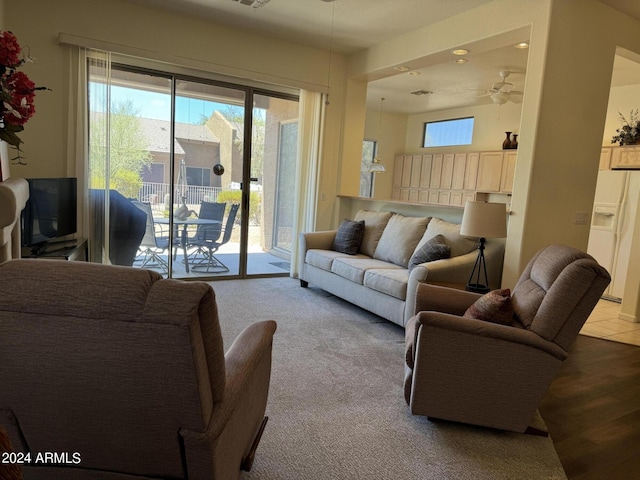 living area featuring a ceiling fan and visible vents