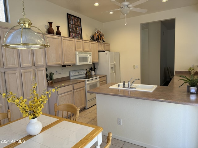 kitchen with white appliances, a peninsula, light tile patterned flooring, recessed lighting, and a sink