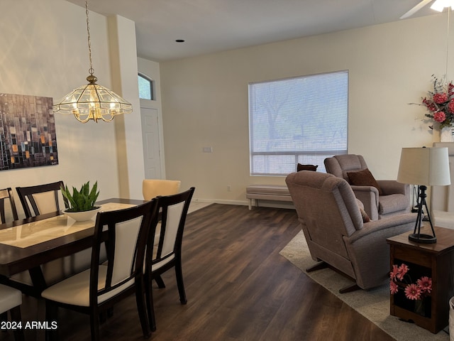 dining space featuring baseboards, an inviting chandelier, and dark wood-style flooring