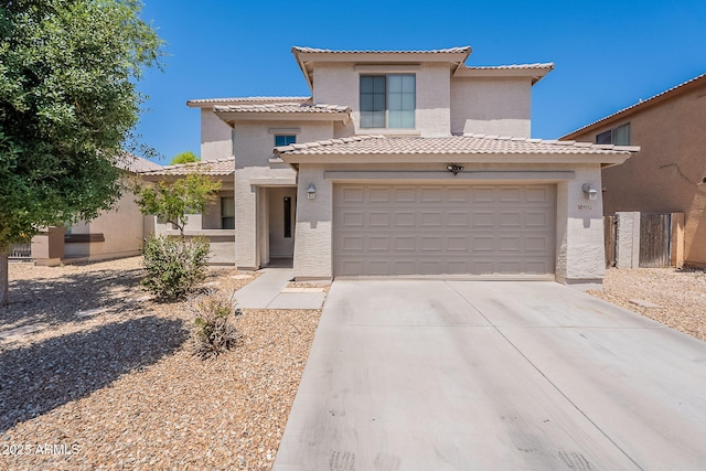 view of front of property with concrete driveway, a tiled roof, stucco siding, and an attached garage